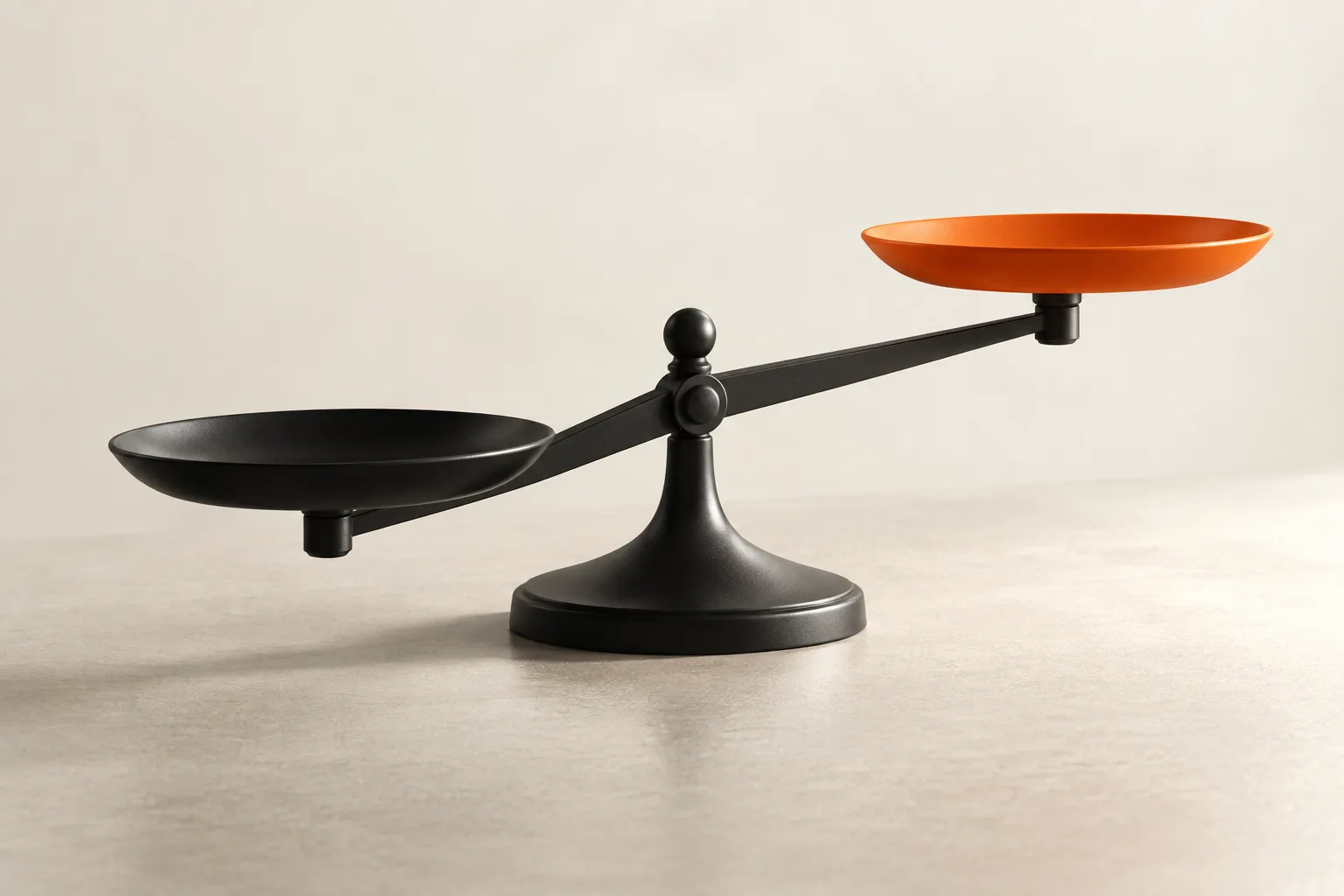 A black balance whose orange side rises higher.