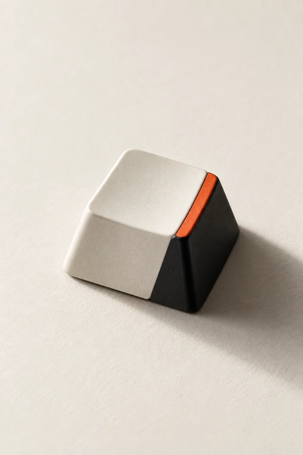 A single keyboard key in white and black with an orange edge.