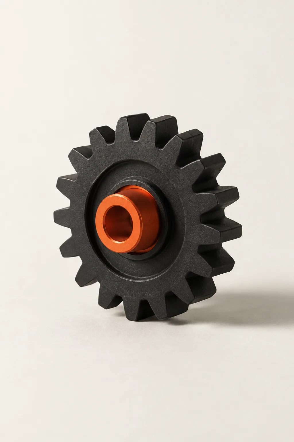 A black gear with an orange hub.